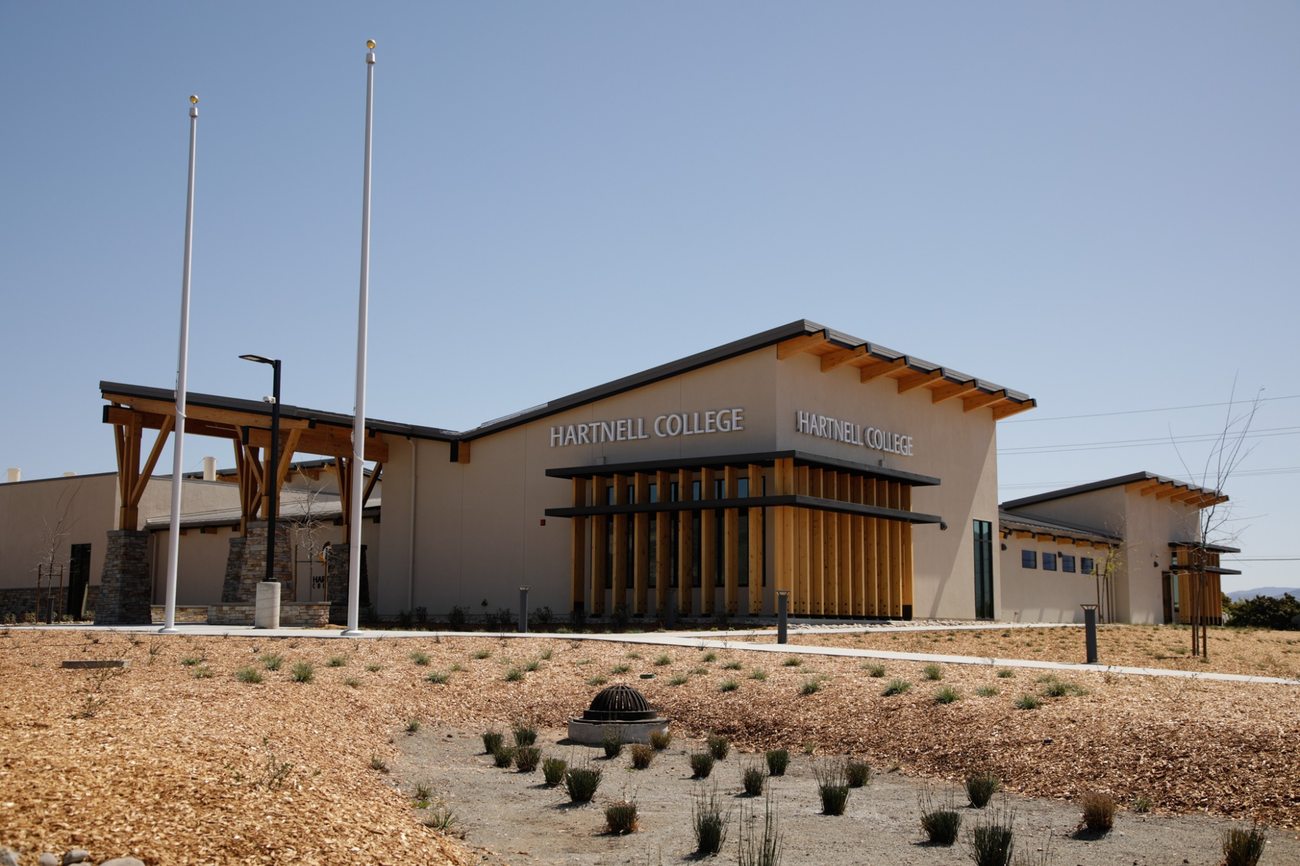 Contemporary Hartnell College building with stone and wood entrance details