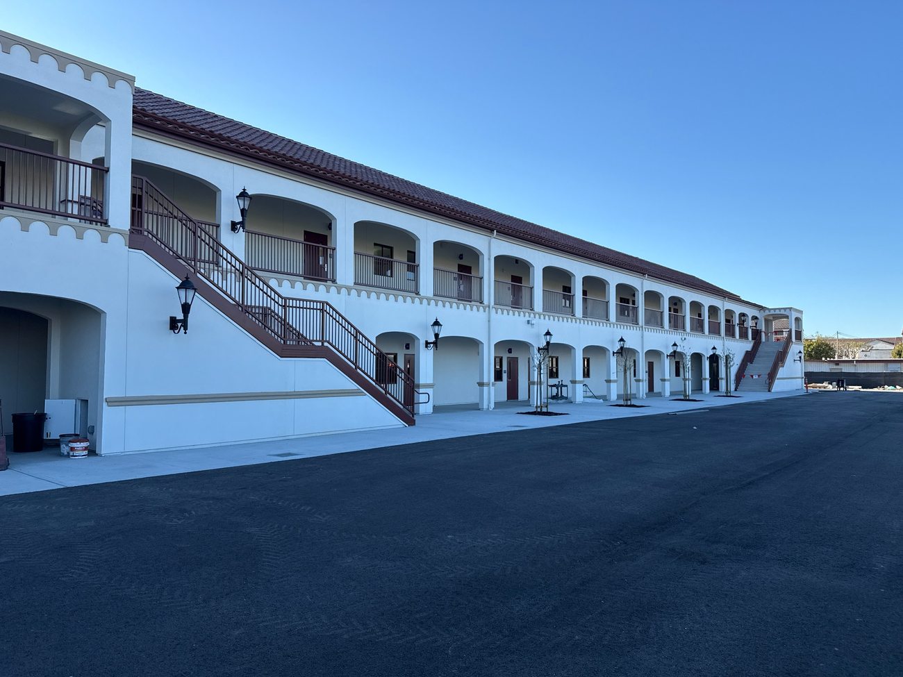Completed two-story classroom building with exterior walkways and stairs